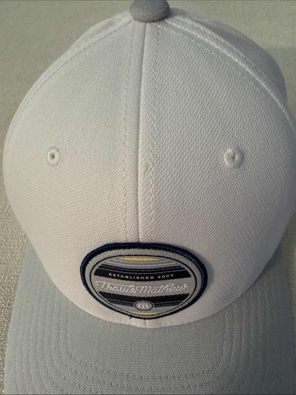 NWOT TravisMathew White and Light Gray Performance Golf Hat with Logo Patch